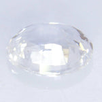 Macro of earth-sourced white sapphire oval cut — clean facets and luster