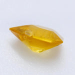 Freeform yellow sapphire with calipers: 5.67 × 4.55 × 2.81 mm