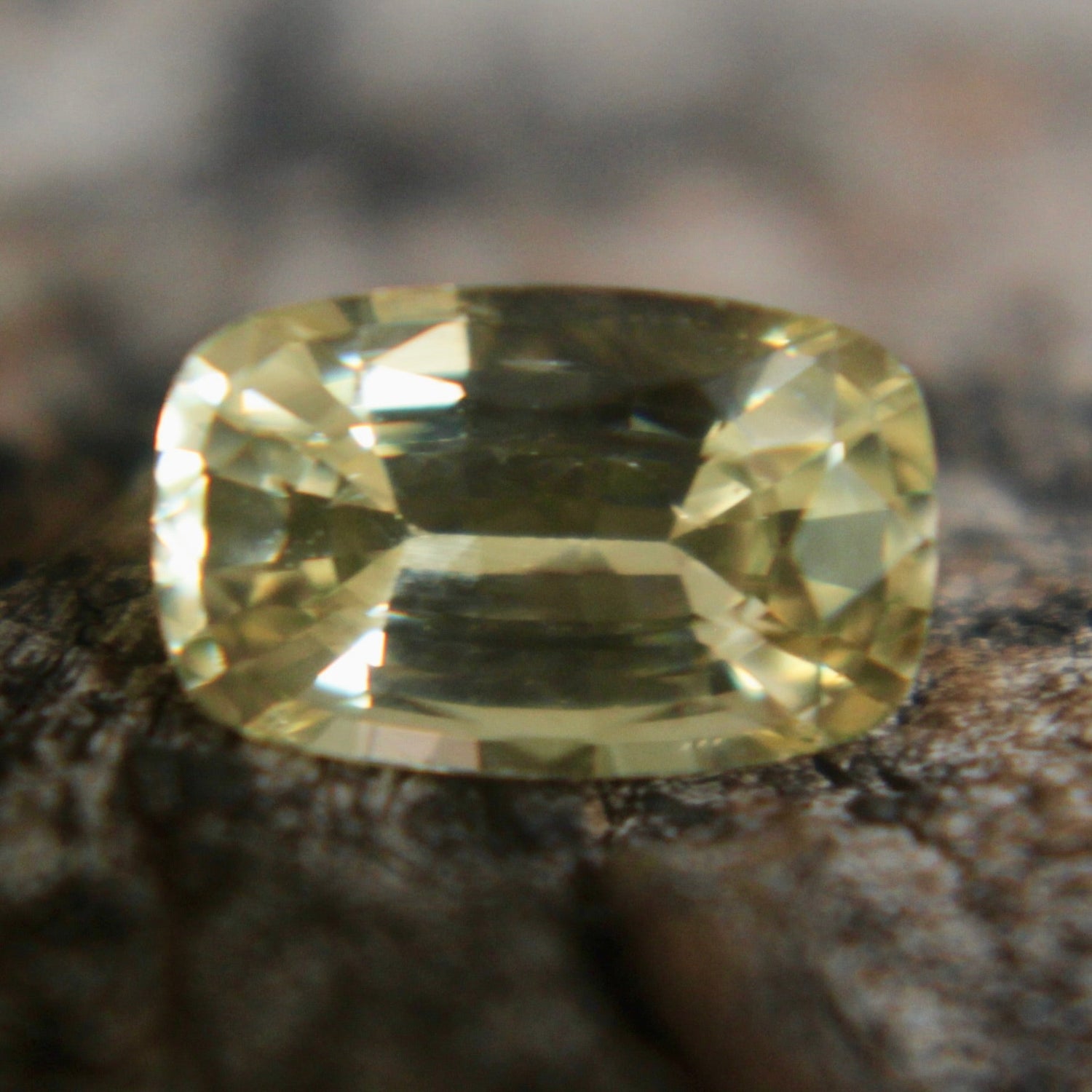 Cushion-cut yellow sapphire showing bright golden hue and fine faceting