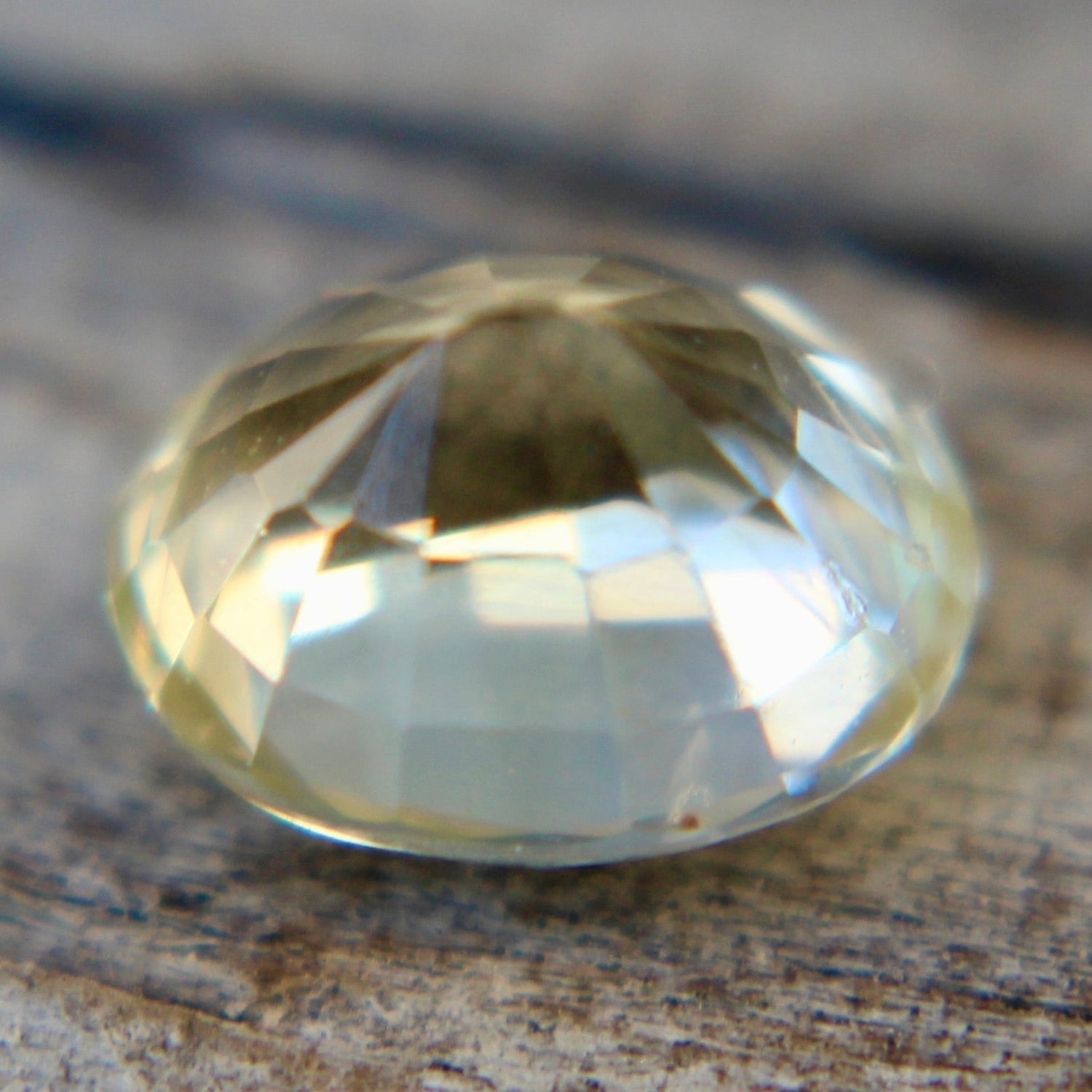Oval yellow sapphire loose gemstone showing bright facets