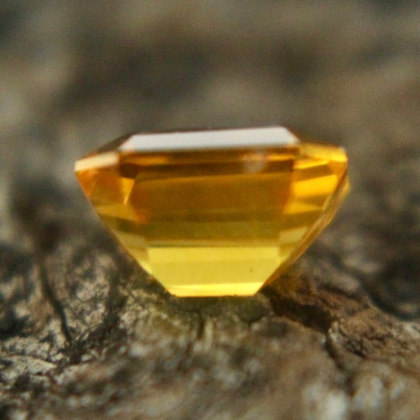 Emerald cut yellow sapphire with calipers: 5.42 × 3.98 × 3.32 mm