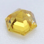 Freeform yellow sapphire showing golden hue and lively facets