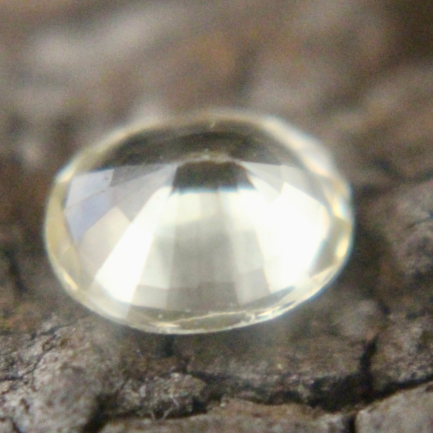 Oval yellow sapphire 0.80 carat showing bright facets in neutral light