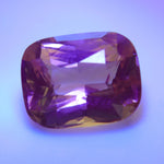 Color change alexandrite showing orange tone under incandescent light