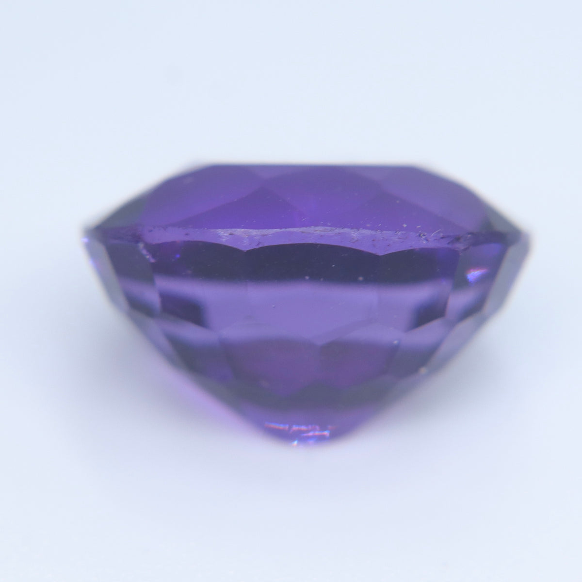 Close-up of the table and crown facets of an oval amethyst
