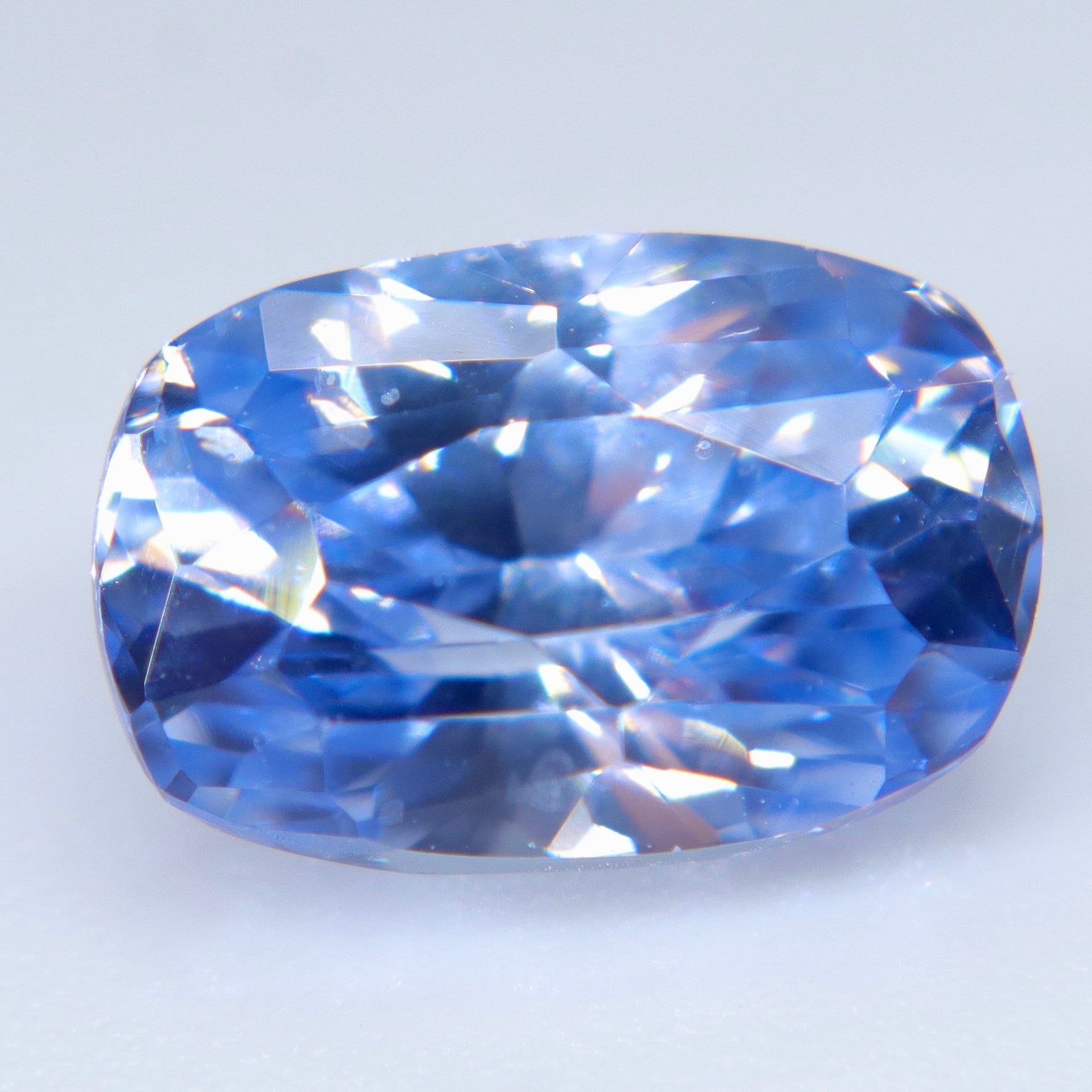 Pale blue cushion cut sapphire for bespoke engagement ring or fine jewelry