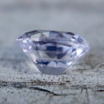 Side profile of a pale purple emerald-cut sapphire
