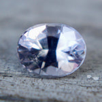 Close-up of the facets on a pale purple emerald-cut sapphire