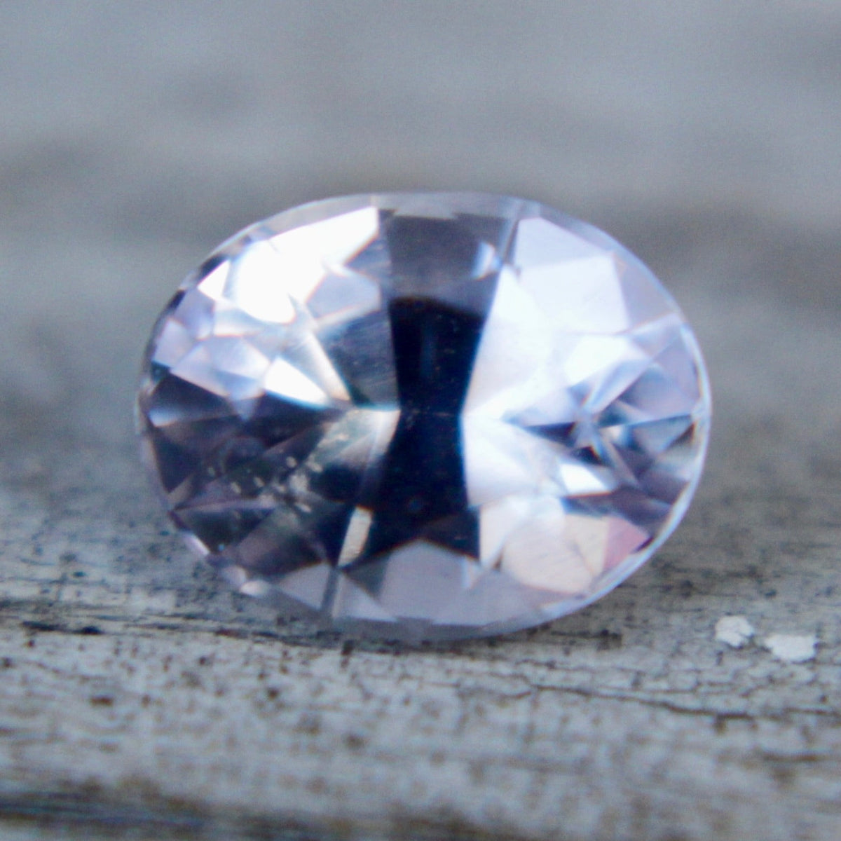 Close-up of the facets on a pale purple emerald-cut sapphire