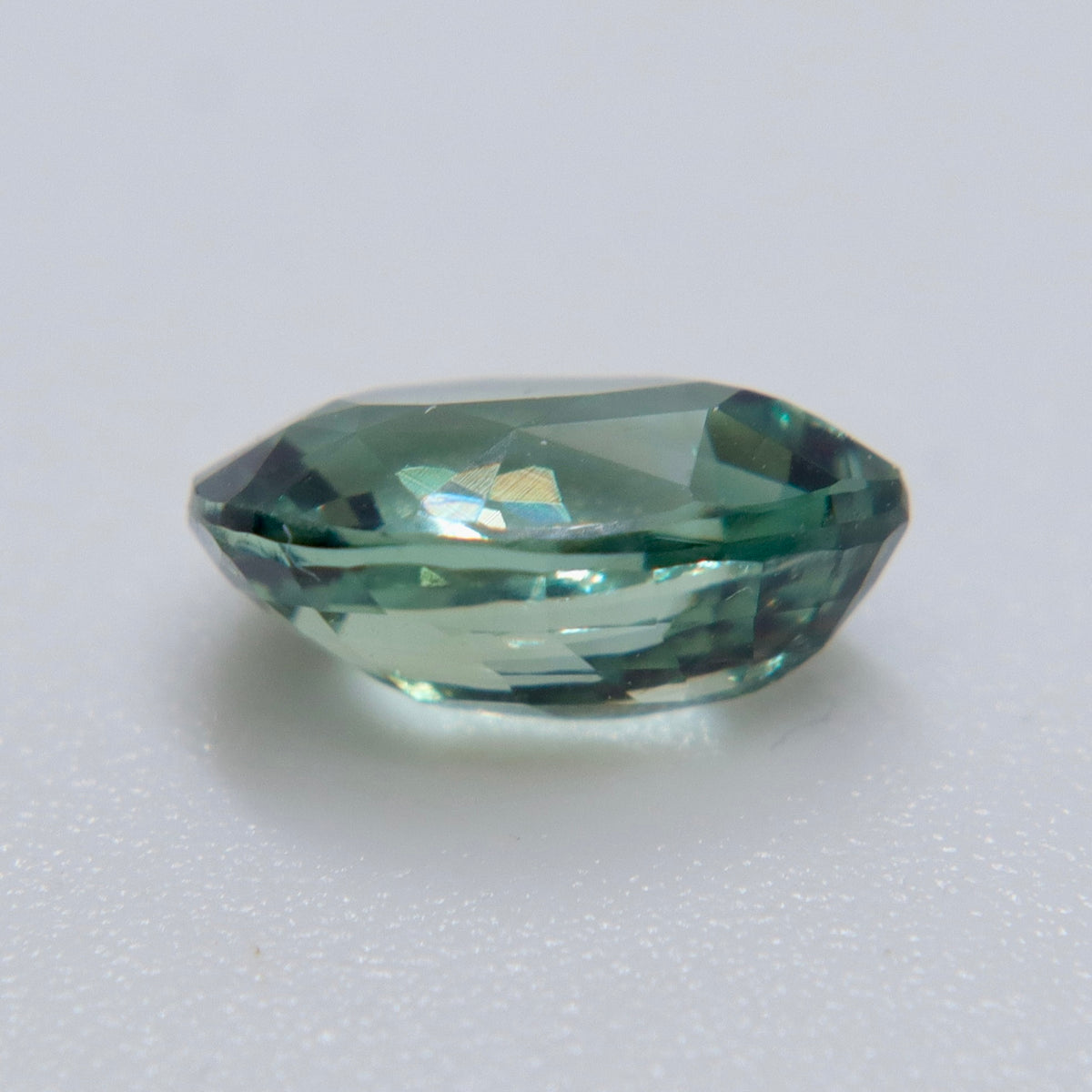 Close-up of the crown facets and pointed tip of a pear-cut natural alexandrite.