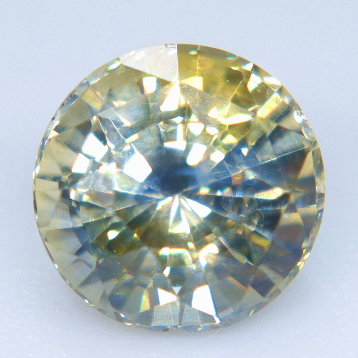 VS clarity blue yellow sapphire in a brilliant round faceted cut