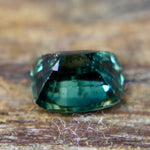 Close-up of the table and surrounding facets of a teal green sapphire