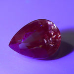 Unheated pear-cut alexandrite displaying green tones under daylight-style lighting