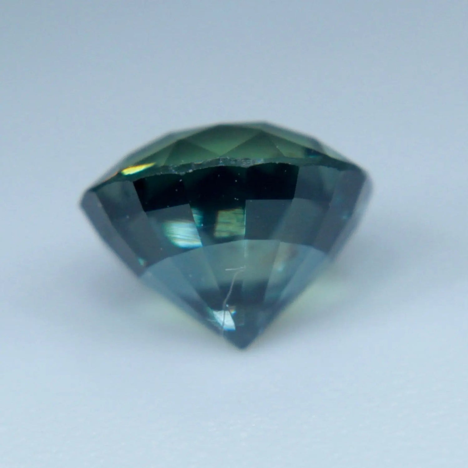 Unheated Ceylon blue-green sapphire showing roundish oval facets