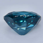 Side profile of an untreated oval teal blue spinel from Ceylon
