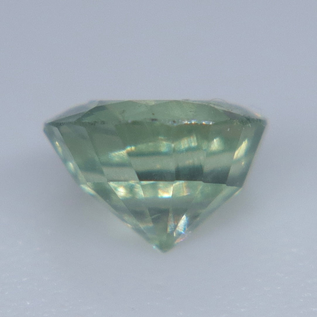 Untreated round-cut green sapphire from Madagascar showing soft mint and yellow-green tones