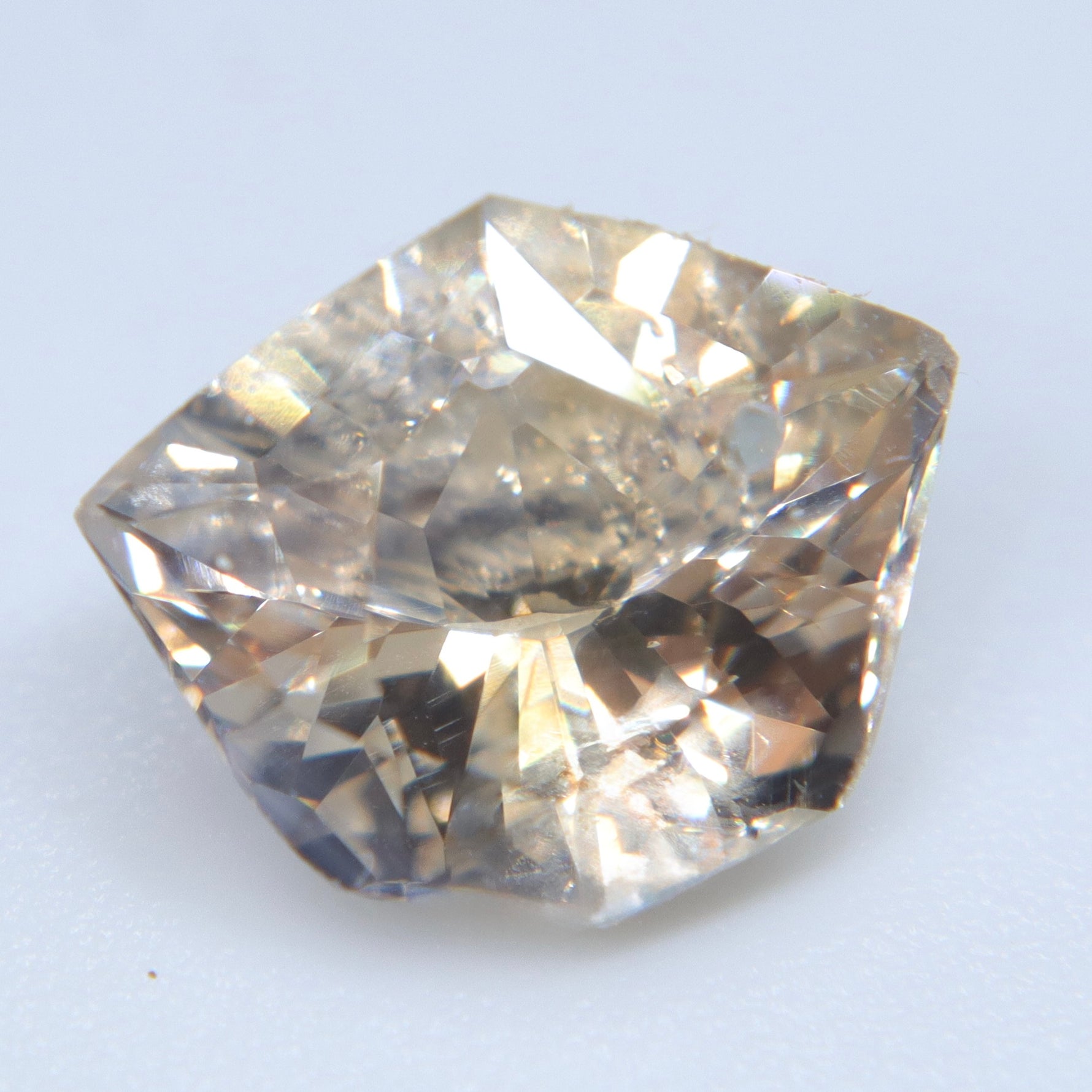 Alternate face-up view of the 2.77ct natural champagne sapphire showing facets and visible inclusions