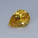 Loose vivid yellow sapphire measuring approximately 6.82 by 5.13 mm