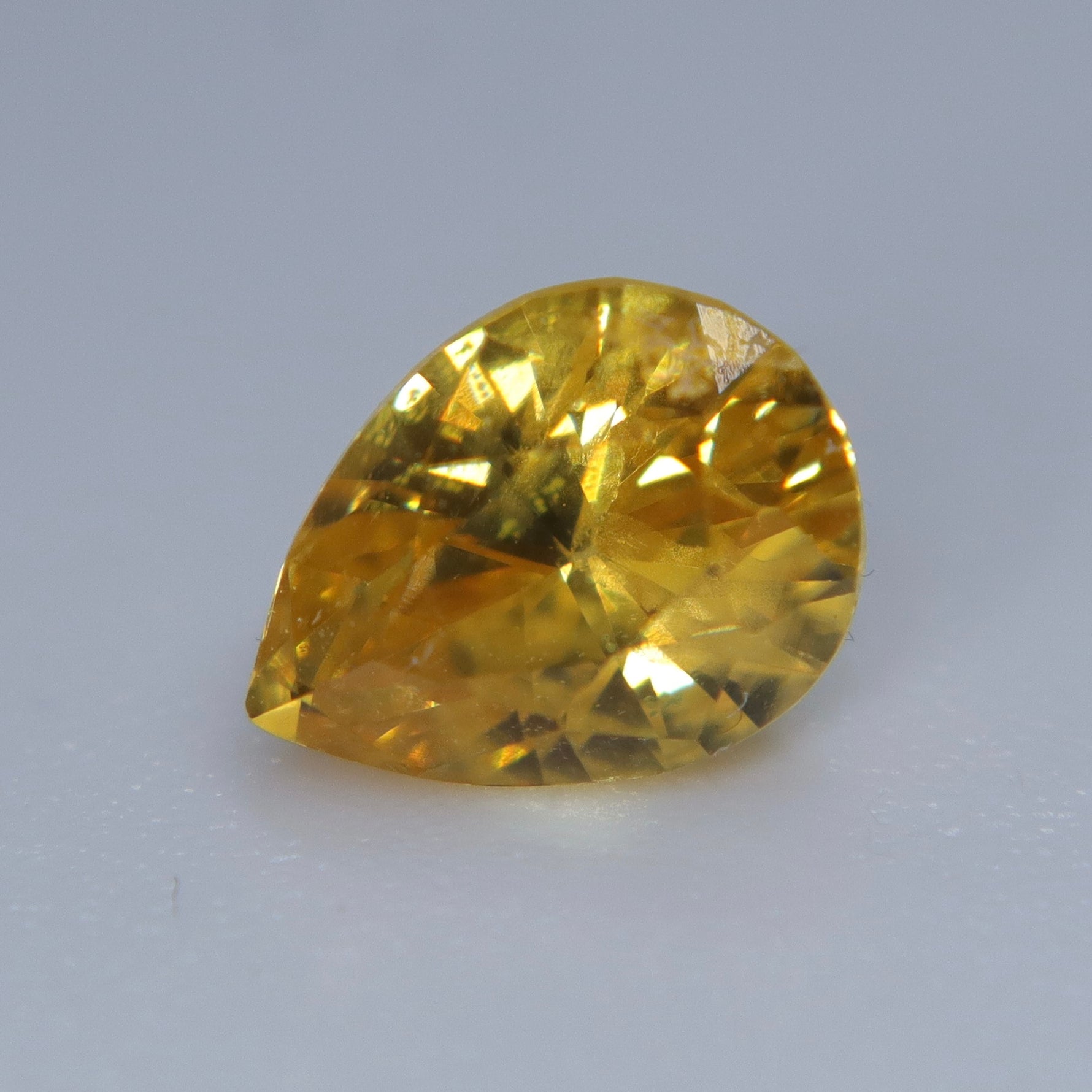 Loose vivid yellow sapphire measuring approximately 6.82 by 5.13 mm