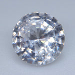 Loose white sapphire measuring approximately 6.81 mm in diameter