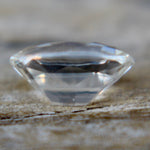 Natural white sapphire measuring approximately 7.45 by 5.61 mm