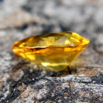 Natural yellow sapphire measuring approximately 7.38 by 5.33 mm